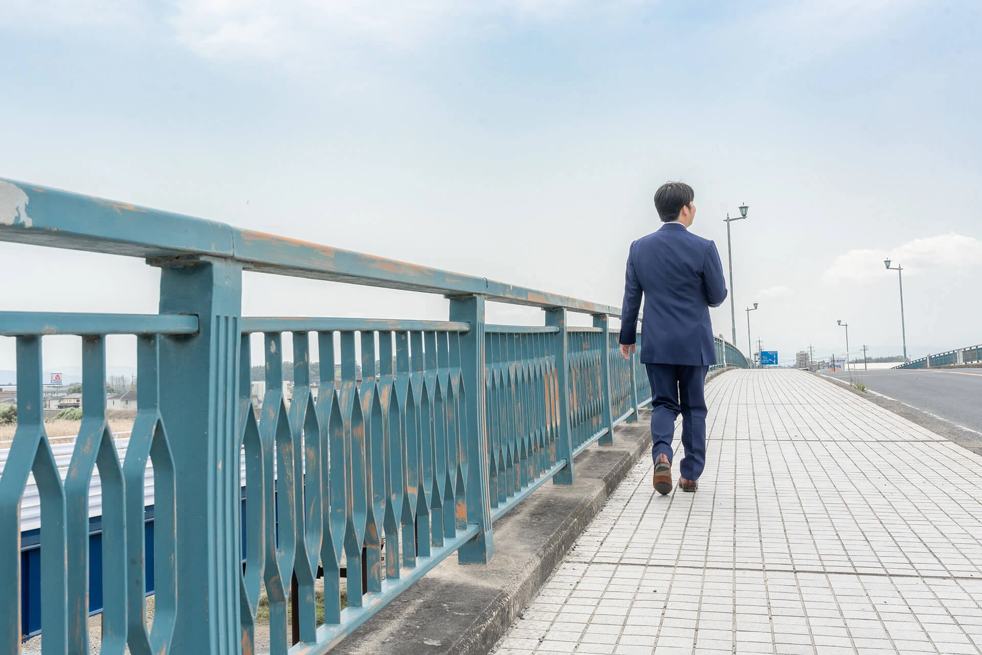 税理士東憲吾が伊賀市の橋を歩いている。